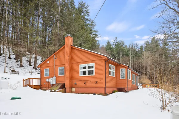 a view of a house with a yard covered in snow