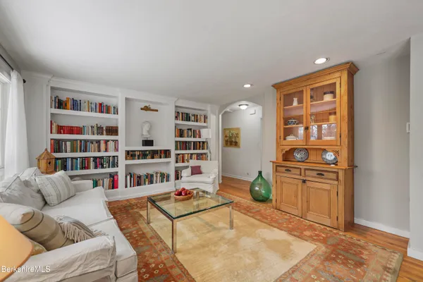 a living room with furniture cabinets and book shelf