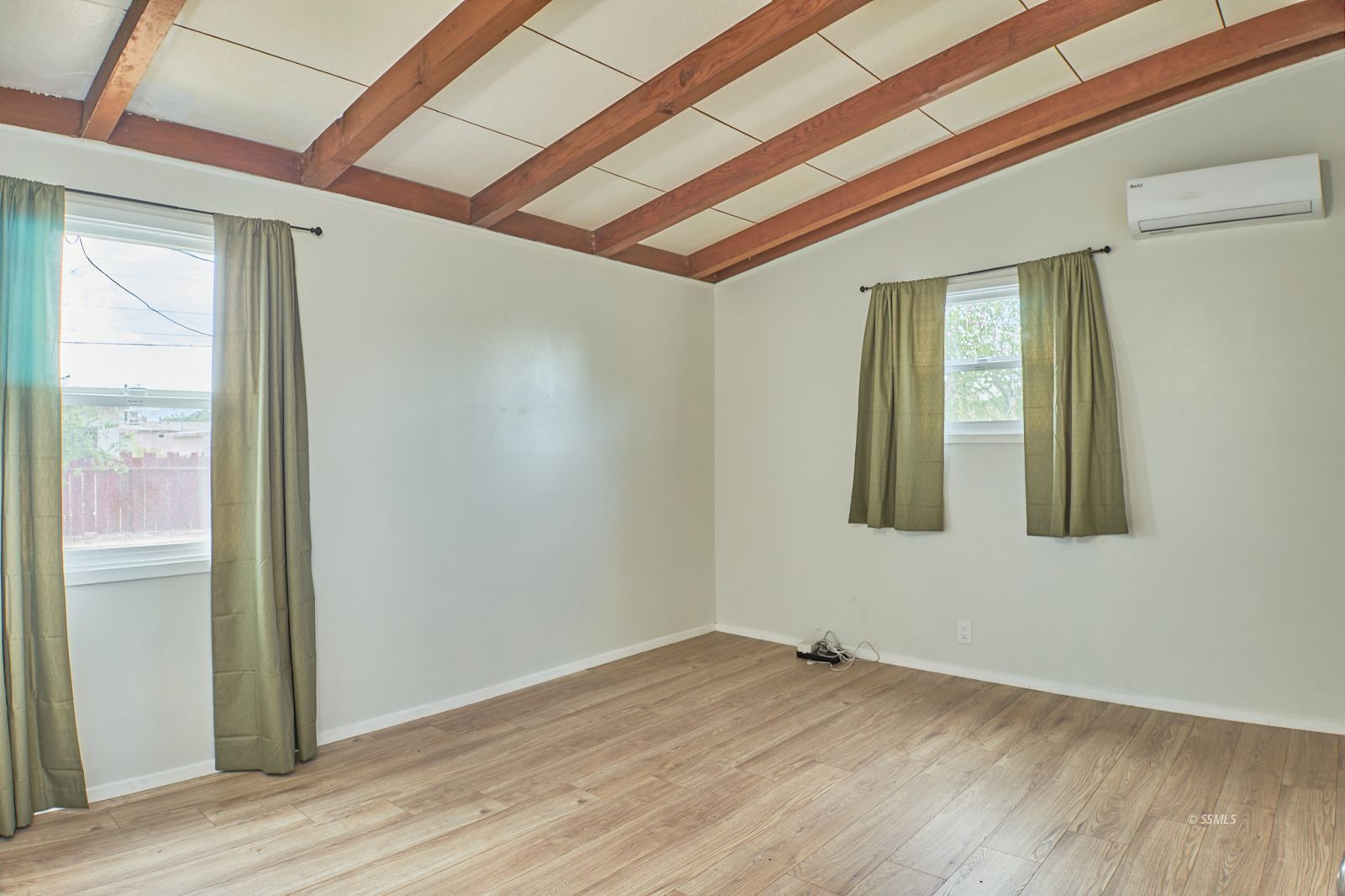 333 North Florence Street Ridgecrest, CA 93555 - Photo 17 of 30 a view of an empty room with wooden floor and a window