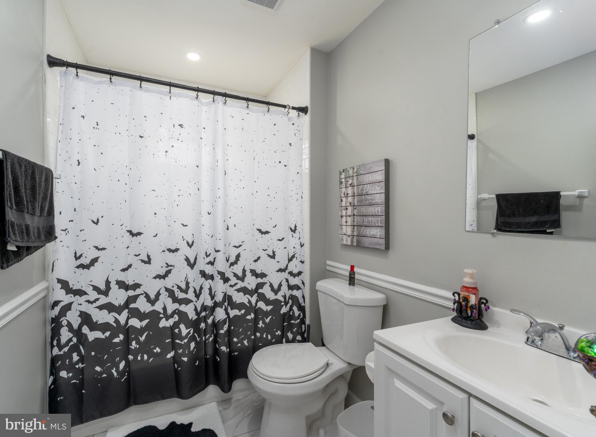 2519 Wycliffe Road Parkville, MD 21234 - Photo 23 of 26 a bathroom with a toilet sink and mirror