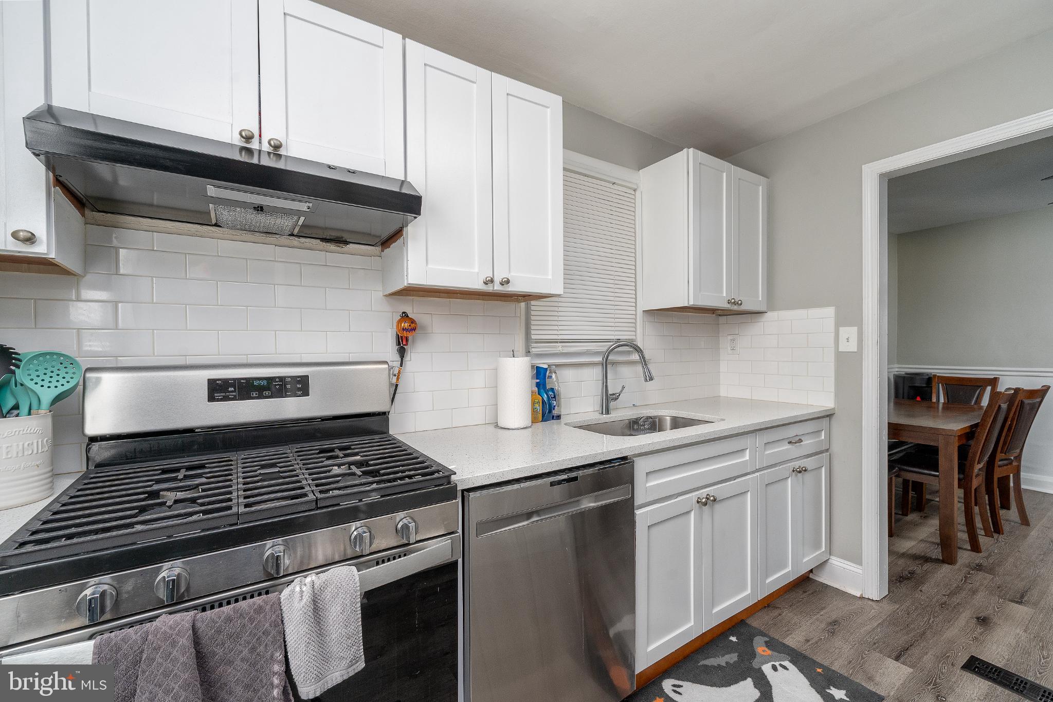 2519 Wycliffe Road Parkville, MD 21234 - Photo 6 of 26 a kitchen with a stove and white cabinets