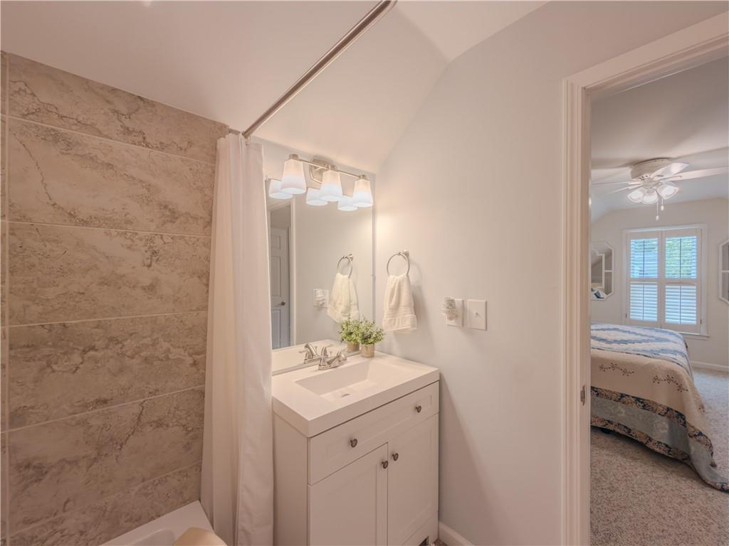 4284 Cedar Bluff Way Southwest Lilburn, GA 30047 - Photo 42 of 62 a en suite bathroom with a sink and a mirror