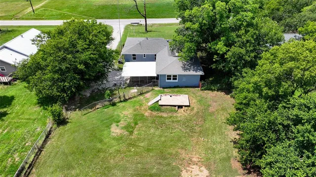 a aerial view of a house with swimming pool garden and patio