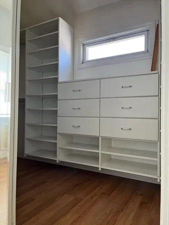 a view of walk in closet with empty racks
