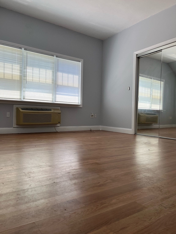 17 Hill Street, Unit 2 Quincy, MA 02169 - Photo 5 of 8 a view of room with window and wooden floor