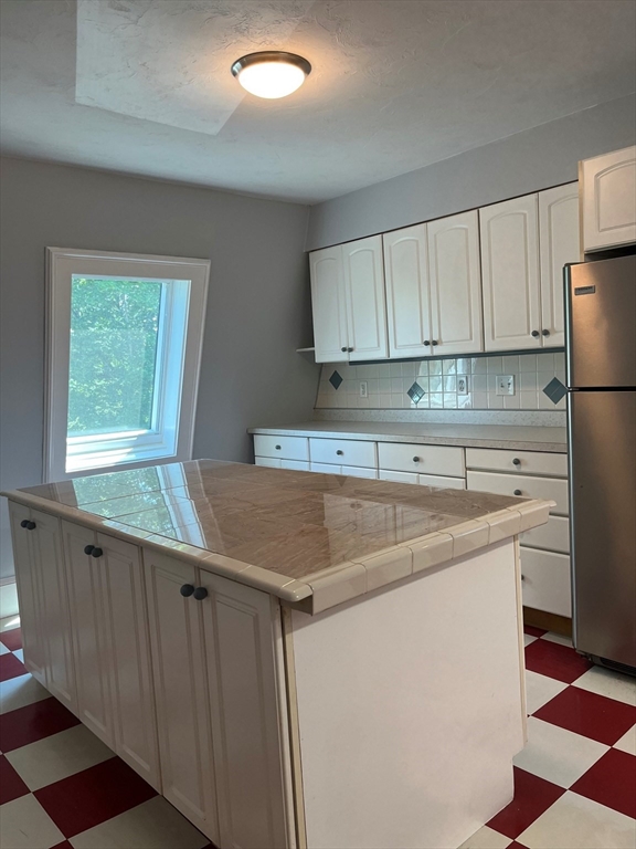 17 Hill Street, Unit 2 Quincy, MA 02169 - Photo 6 of 8 a kitchen with stainless steel appliances granite countertop a sink stove and refrigerator