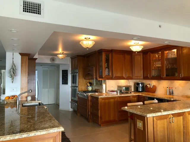 a kitchen with a stove a sink and a microwave