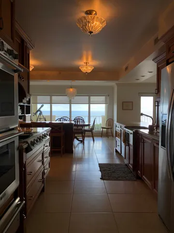 a kitchen with a table chairs and flat screen tv