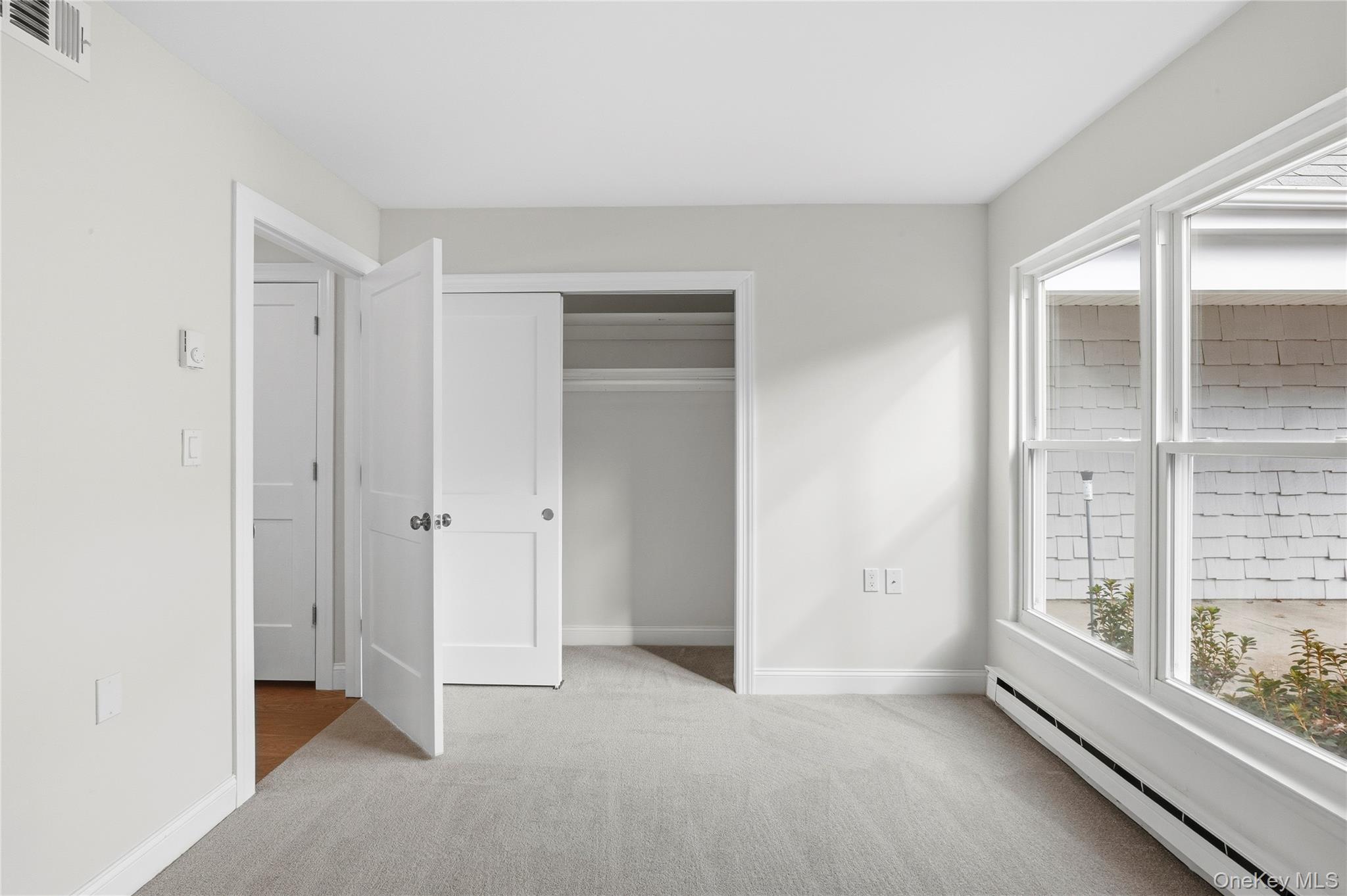 145 Edinburgh Drive Ridge, NY 11961 - Photo 12 of 13 an empty room with windows