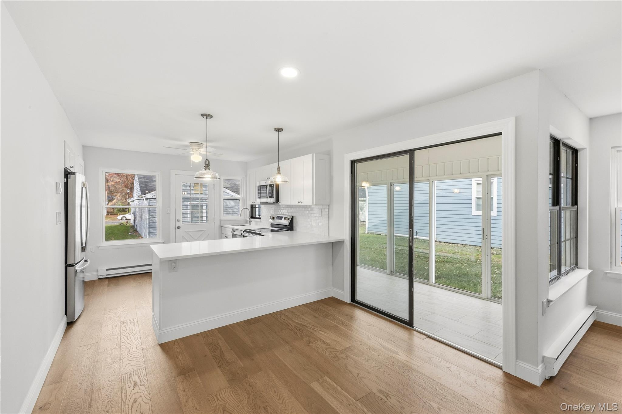 145 Edinburgh Drive Ridge, NY 11961 - Photo 7 of 13 a view of kitchen with sink and refrigerator