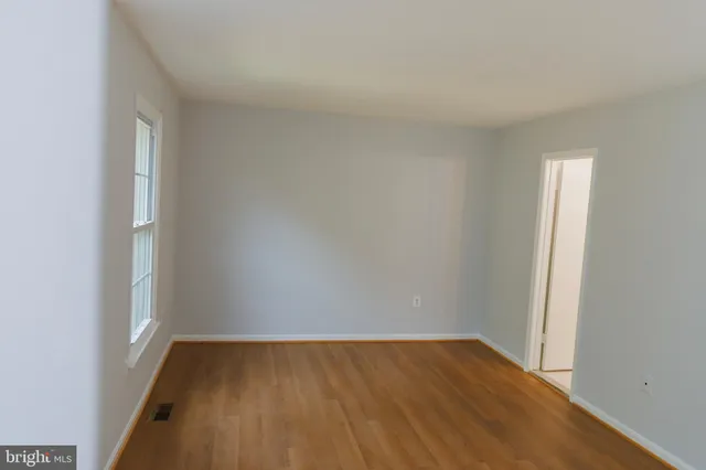a view of an empty room and wooden floor