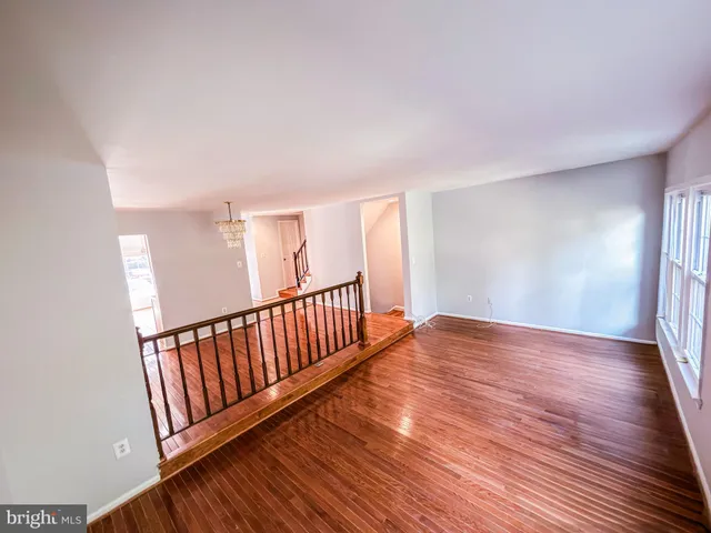 a view of a room with wooden floor