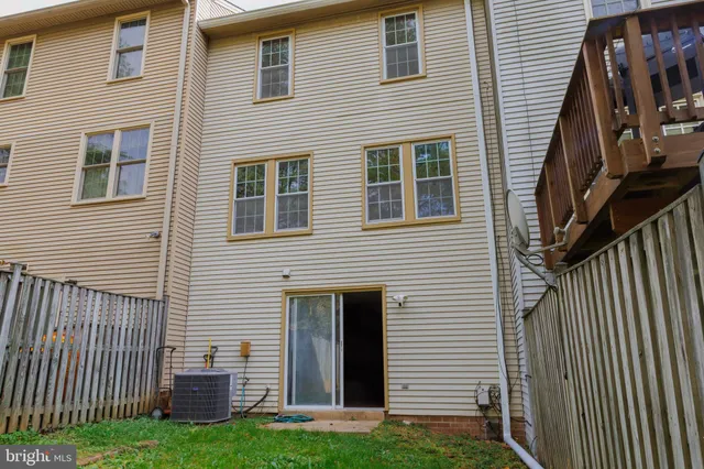 a view of a house with wooden fence