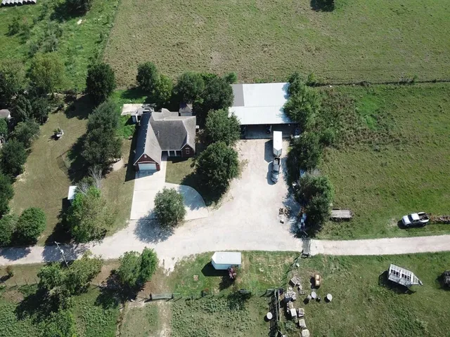 an aerial view of a house with a yard