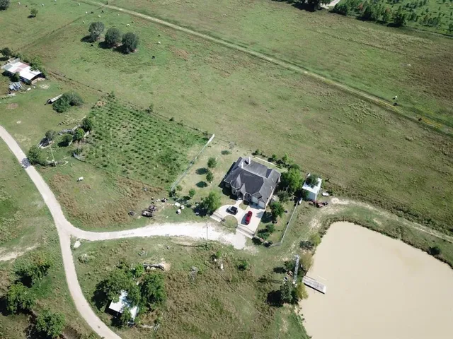 an aerial view of a house with a yard