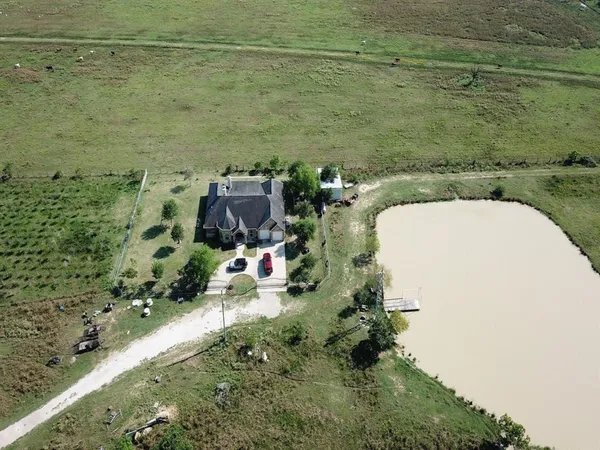 an aerial view of a house with a yard