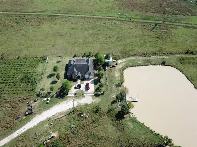 an aerial view of a house with a yard