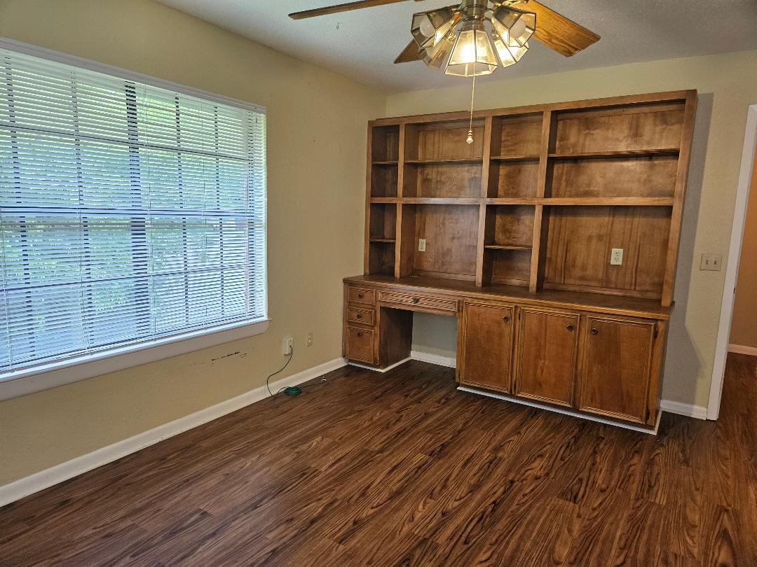 16 North Ave A, Unit B Elgin, TX 78621 - Photo 7 of 17 Primary bedroom with built in bookshelves and desk