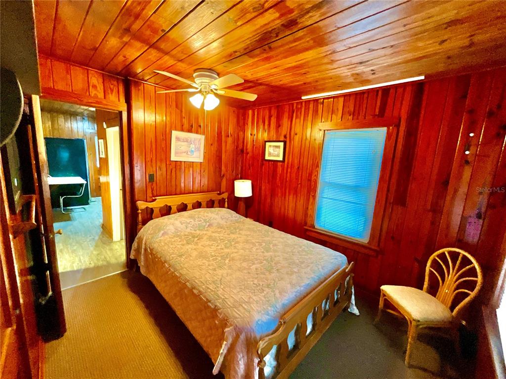 106 Sunny Side Beach Road Hawthorne, FL 32640 - Photo 16 of 54 a bed room with a bed and a chair