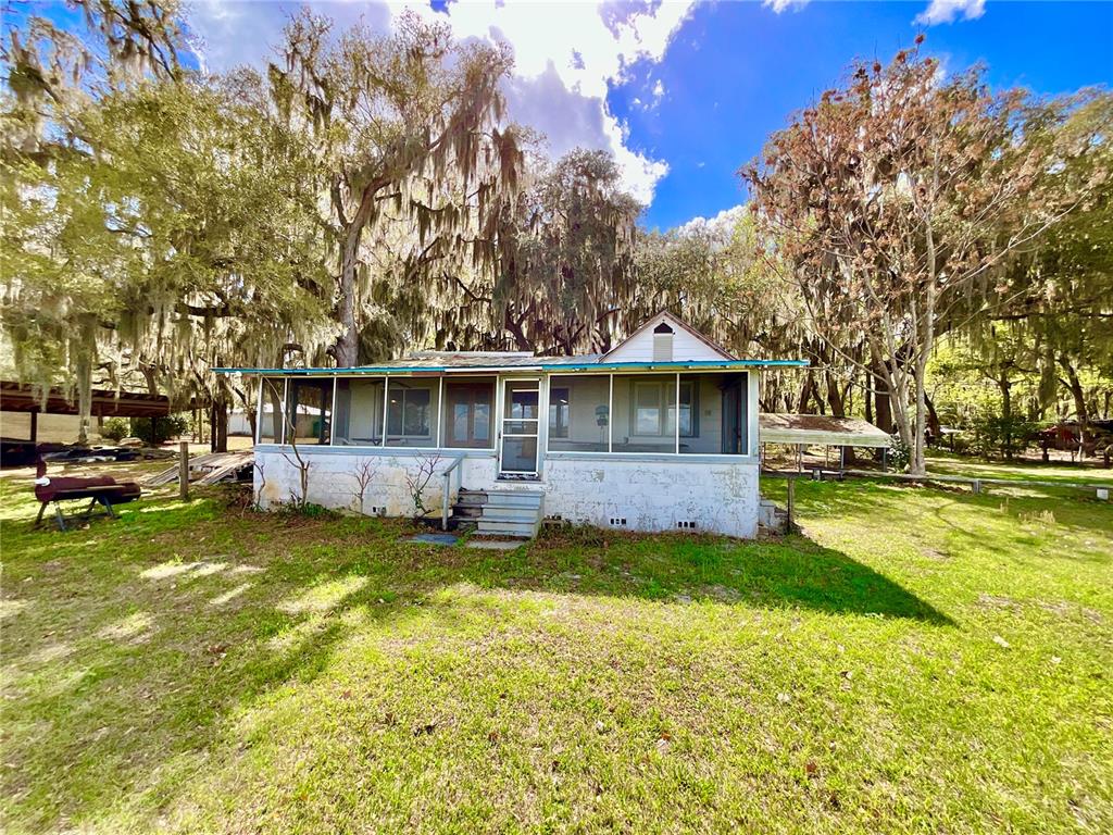 106 Sunny Side Beach Road Hawthorne, FL 32640 - Photo 20 of 54 a view of a house with a big yard and large trees