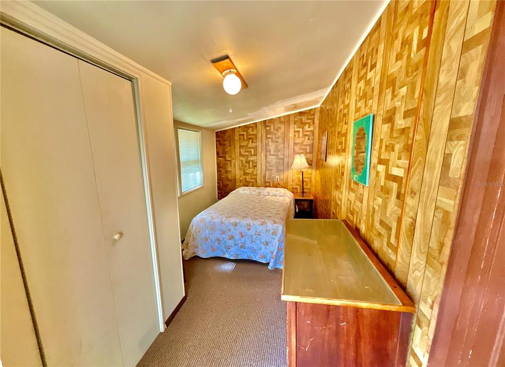 106 Sunny Side Beach Road Hawthorne, FL 32640 - Photo 21 of 54 a bedroom with a bed and wooden floor