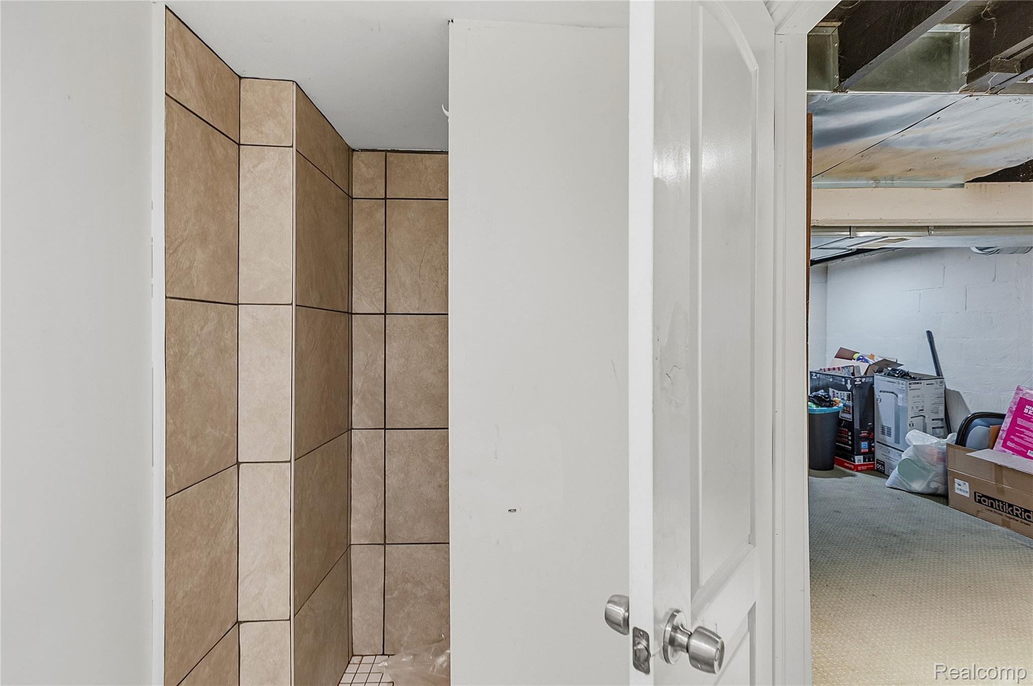 11429 East Eight Mile Road Warren, MI 48089 - Photo 17 of 23 Bathroom featuring concrete block wall and a shower