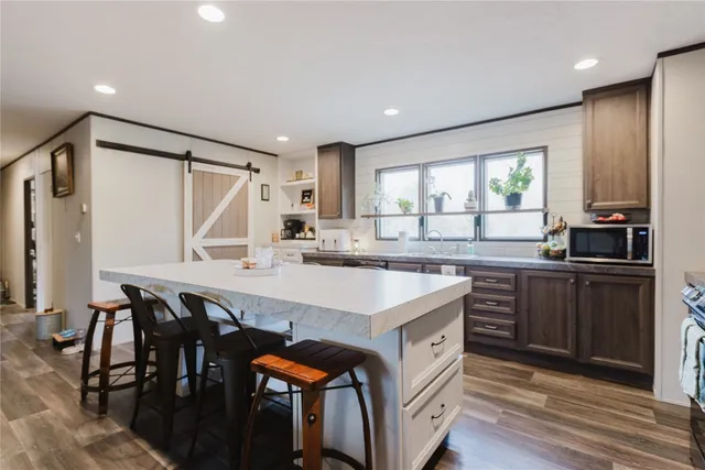 a kitchen with granite countertop a sink and appliances