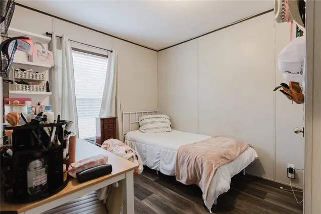 a bedroom with a bed and a window