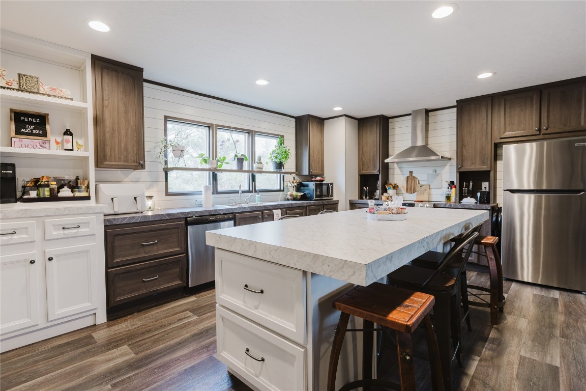 400 St Johns Road Dale, TX 78616 - Photo 2 of 17 Kitchen with stainless steel appliances, a breakfast bar, white cabinetry, light countertops, and open shelves