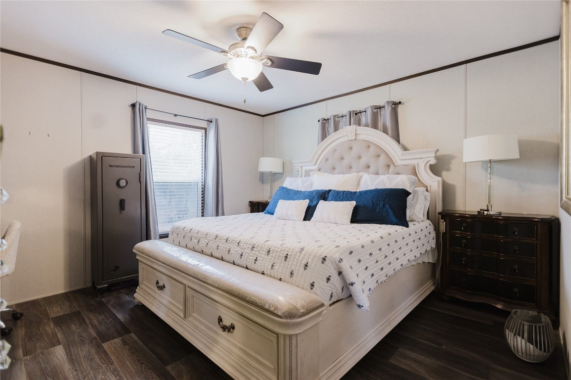 400 St Johns Road Dale, TX 78616 - Photo 7 of 17 Bedroom with ornamental molding, dark wood-style flooring, and a ceiling fan