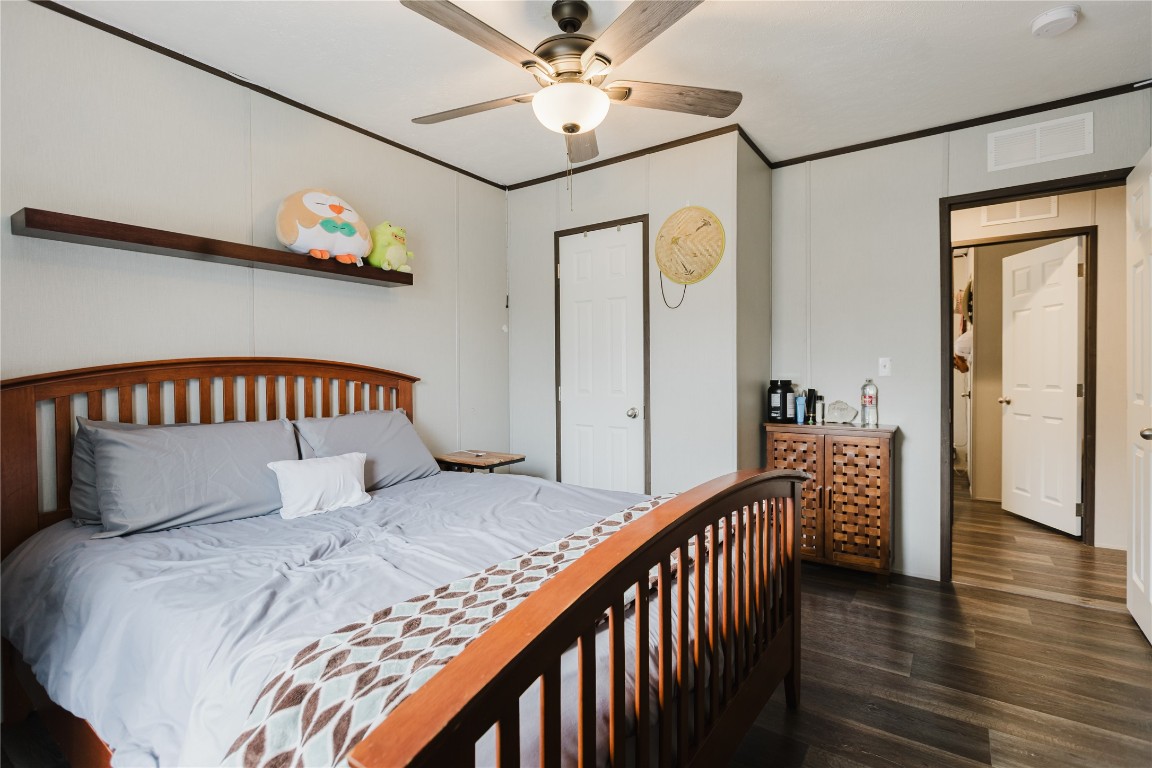 400 St Johns Road Dale, TX 78616 - Photo 9 of 17 Bedroom featuring ornamental molding, ceiling fan, and dark wood finished floors