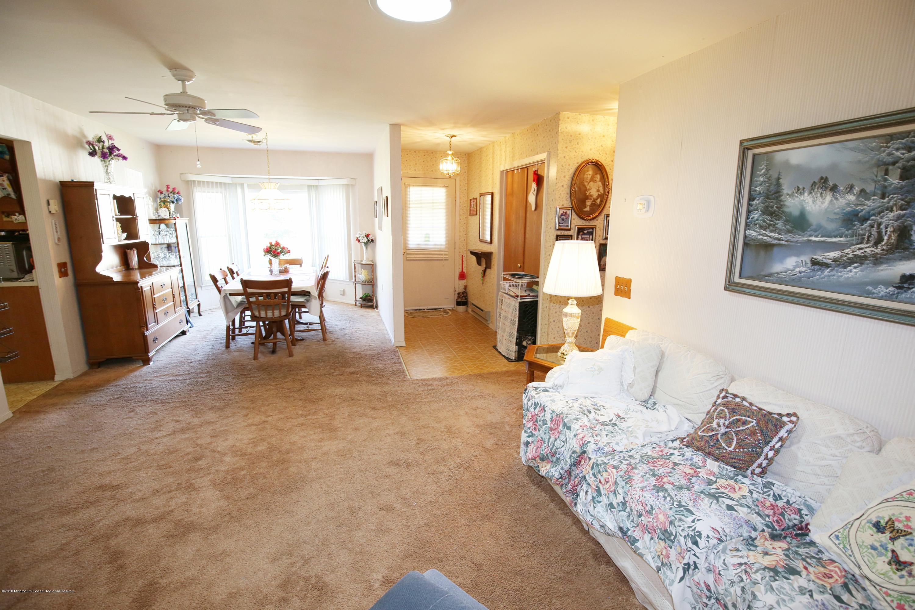 30A Mill Road, Unit C Whiting, NJ 08759 - Photo 12 of 23 a bedroom with furniture and a large mirror