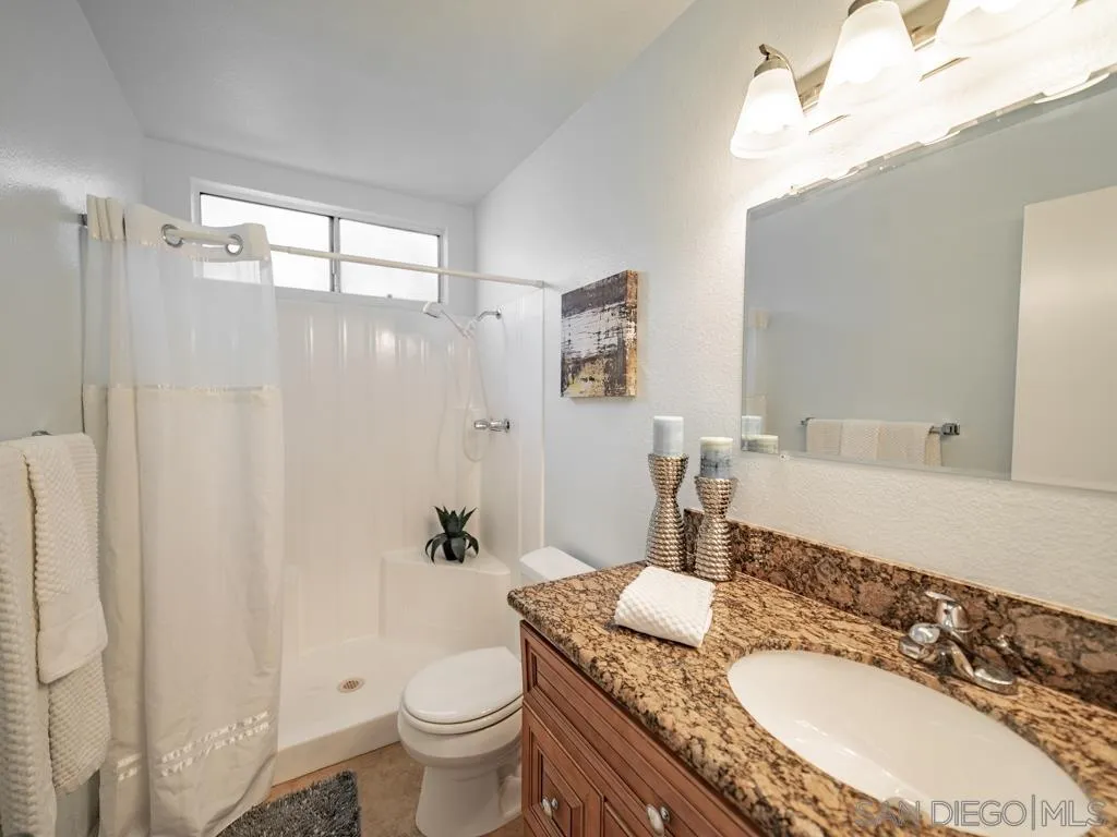 10911 Eddington Road Santee, CA 92071 - Photo 18 of 25 a bathroom with a granite countertop sink toilet and shower