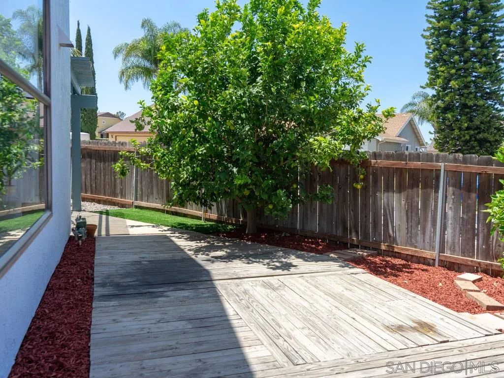 10911 Eddington Road Santee, CA 92071 - Photo 24 of 25 a view of backyard with wooden fence and large trees