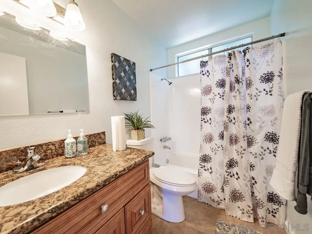 10911 Eddington Road Santee, CA 92071 - Photo 9 of 25 a bathroom with a granite countertop sink toilet and shower