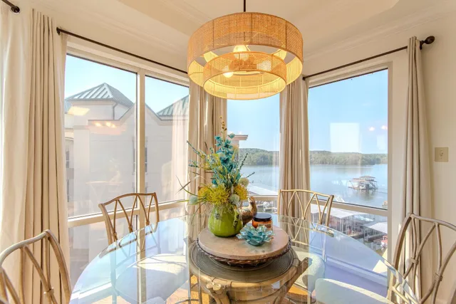 a dining room with furniture a chandelier and wooden floor