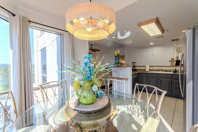 a view of a dining room with furniture a chandelier and wooden floor