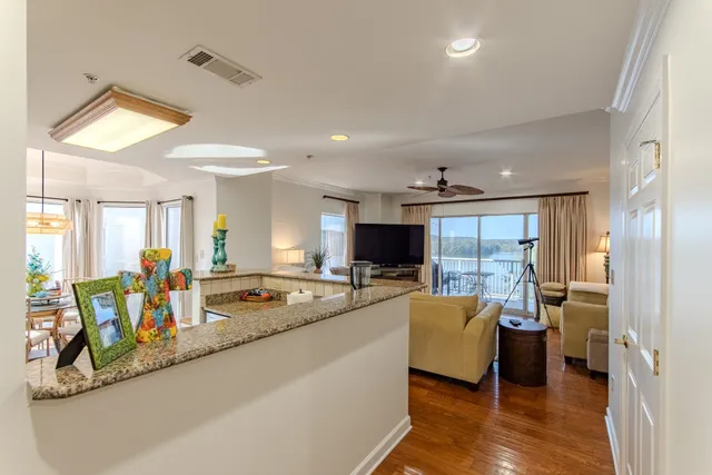 a large living room with stainless steel appliances granite countertop a couch and a view of living room