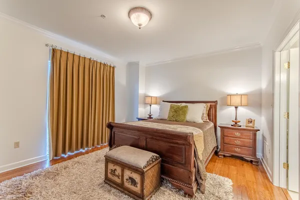 a bedroom with a bed and a night stand