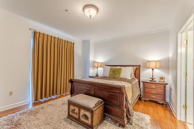 a bedroom with a bed and a night stand