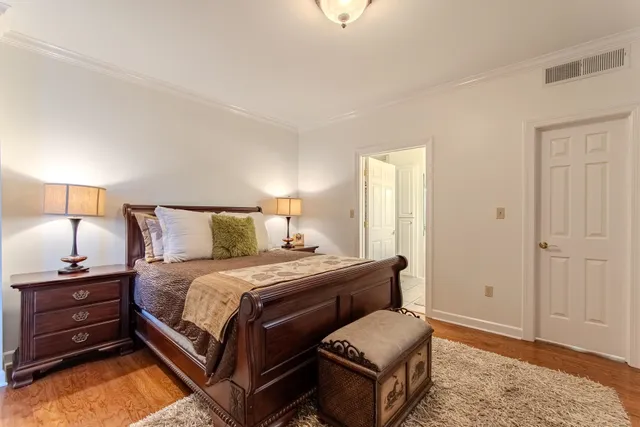 a bedroom with a bed and a lamp