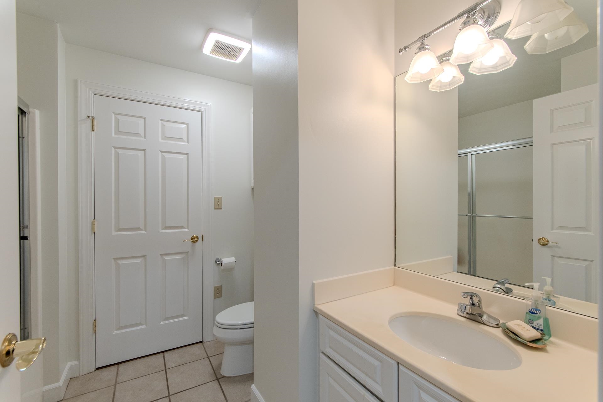 323 Cr 380 Road, Unit P604 Iuka, MS 38852 - Photo 21 of 38 a bathroom with a toilet a sink a mirror and vanity