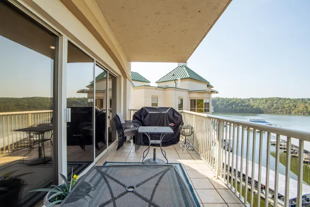a view of a balcony with chairs and wooden floor