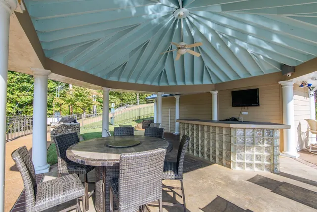 a outdoor dining space with furniture and umbrella