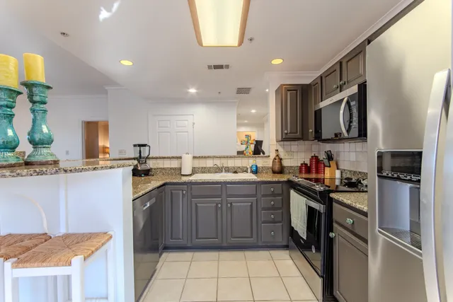 a kitchen with a sink cabinets and stainless steel appliances