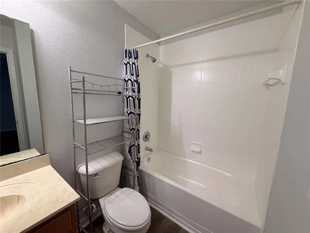 a view of room with wooden floor and staircase
