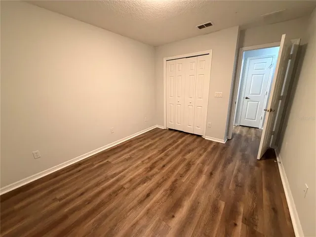 a view of a room with wooden floor and white walls