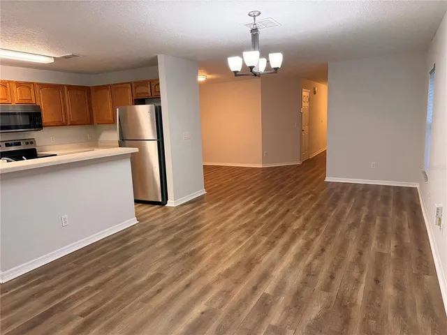 a view of a kitchen with cabinets and wooden floor