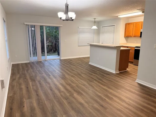 a view of a kitchen with wooden floor and a sink