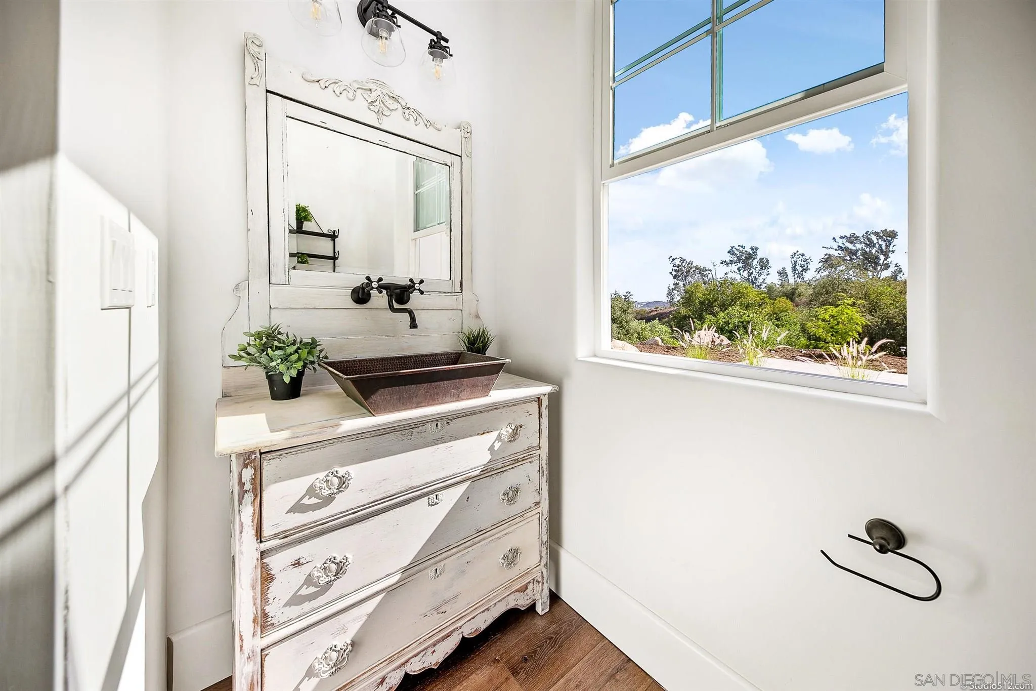 28661 Double K Road Valley Center, CA 92082 - Photo 12 of 34 a bathroom with a sink a mirror and a window